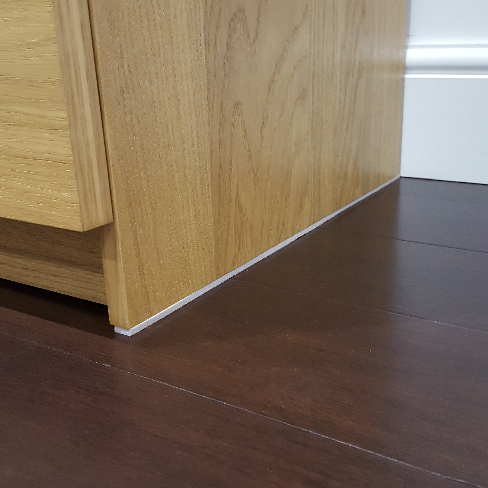Beige furniture felt roll strip applied along the underside of floor standing drawers to provide protection from scratches